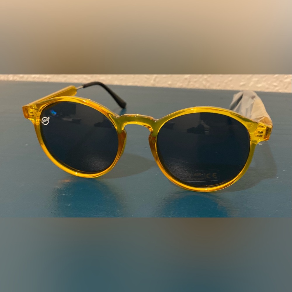 Yellow/Gold round sunglasses with adjustable arms.